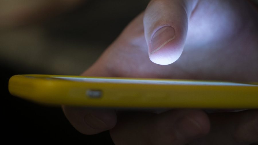 FILE - A man uses a cellphone in New Orleans, Aug. 11, 2019. On Tuesday, May 23, 2023, attorneys general across the U.S. joined in a lawsuit against a telecommunications company accused of making more than 7.5 billion robocalls to people on the national Do Not Call Registry. (AP Photo/Jenny Kane, File)