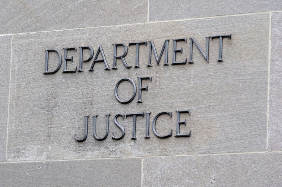 FILE - A sign marks the facade of the Robert F. Kennedy Department of Justice Building, May 5, 2022, in Washington. The Justice Department issued new guidance Thursday, May 25, 2023, emphasizing that investigations must be free from bias involving race and gender or against people with disabilities. Anti-profiling rules were also expanded to include thousands more people who are part of the justice system. (AP Photo/Patrick Semansky, File)