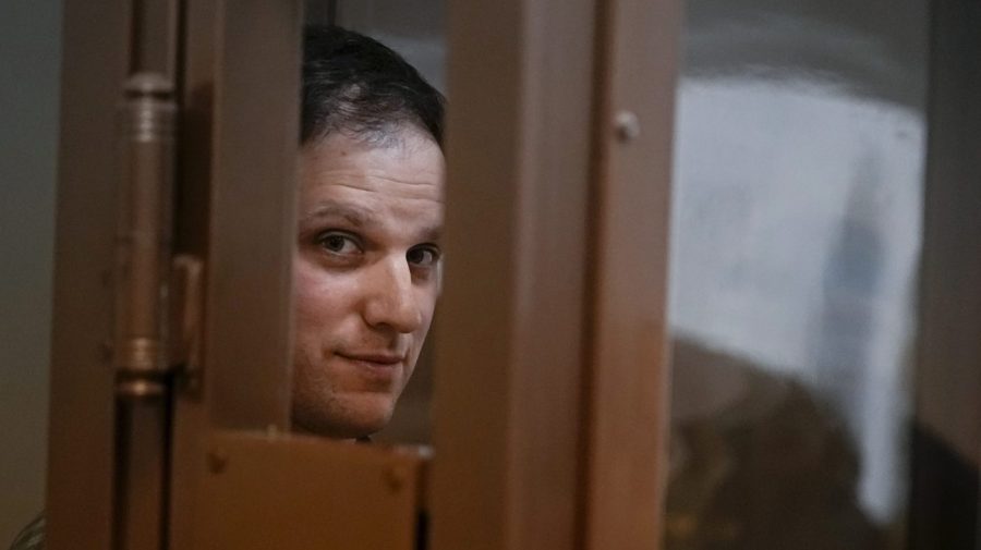 FILE - Wall Street Journal reporter Evan Gershkovich stands in a glass cage in a courtroom at the Moscow City Court, in Moscow, Russia, on April 18, 2023. Gershkovich, a 31-year-old U.S. citizen, was arrested in March while on a reporting trip in Russia. He, his employer and the U.S. government have denied the charges. A Moscow court on Tuesday extended his detention until Aug. 30, and the journalist has appealed the ruling. (AP Photo/Alexander Zemlianichenko, File)