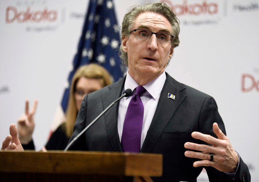 FILE - North Dakota Gov. Doug Burgum speaks at the state Capitol on April 10, 2020, in Bismarck, N.D. Burgum has signed a bill into law that allows public school teachers and state government employees to ignore the pronouns their transgender students and colleagues use, the governor's office announced Monday, May 8, 2023 (Mike McCleary/The Bismarck Tribune via AP, File)