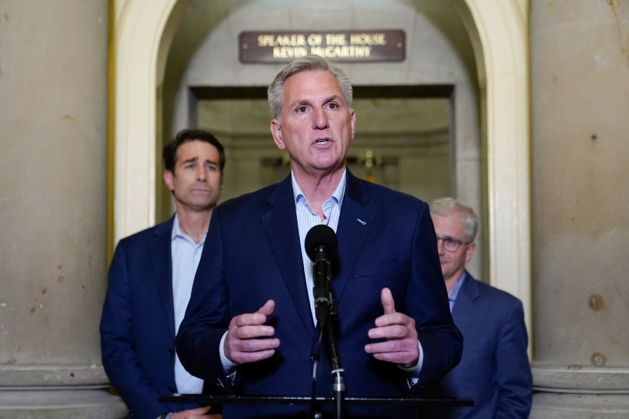 House Speaker Kevin McCarthy of Calif., speaks during a news conference after President Joe Biden and McCarthy reached an "agreement in principle" to resolve the looming debt crisis on Saturday, May 27, 2023, on Capitol Hill in Washington. Rep. Patrick McHenry, R-N.C., a key Republican in the debt limit negotiations and chairman of the House Financial Services Committee, back right, and Rep. Garret Graves, R-La., McCarthy's top mediator in the debt limit talks, left, look on. (AP Photo/Patrick Semansky)