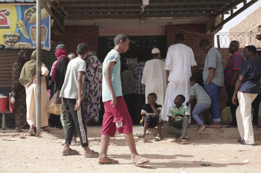 People line up in front of a bakery during a cease-fire in Khartoum, Sudan, Saturday, May 27, 2023. Saudi Arabia and the United States say the warring parties in Sudan are adhering better to a week-long cease-fire after days of fighting. (AP Photo/Marwan Ali)