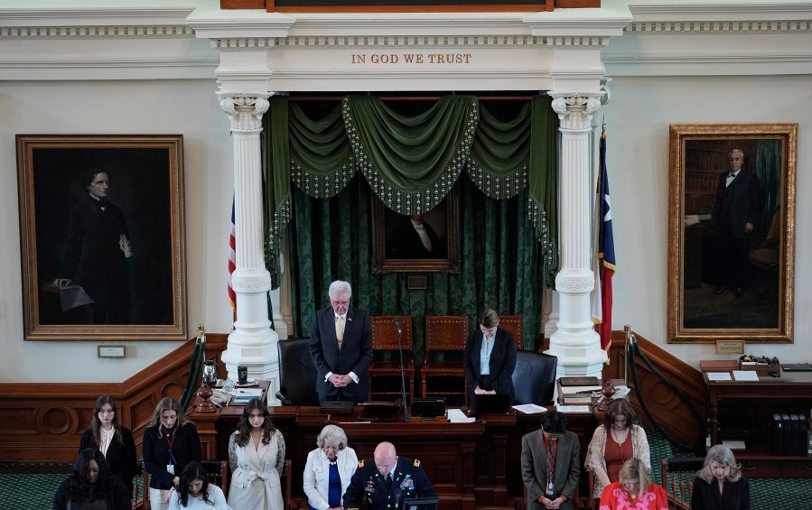 Texas Lt. Gov. Dan Patrick, top left, bows for prayer in the Senate Chamber at the Texas Capitol in Austin, Texas, Monday, May 29, 2023. The historic impeachment of Texas Attorney General Ken Paxton is plunging Republicans into a bruising fight over whether to banish one of their own in America's biggest red state. (AP Photo/Eric Gay)