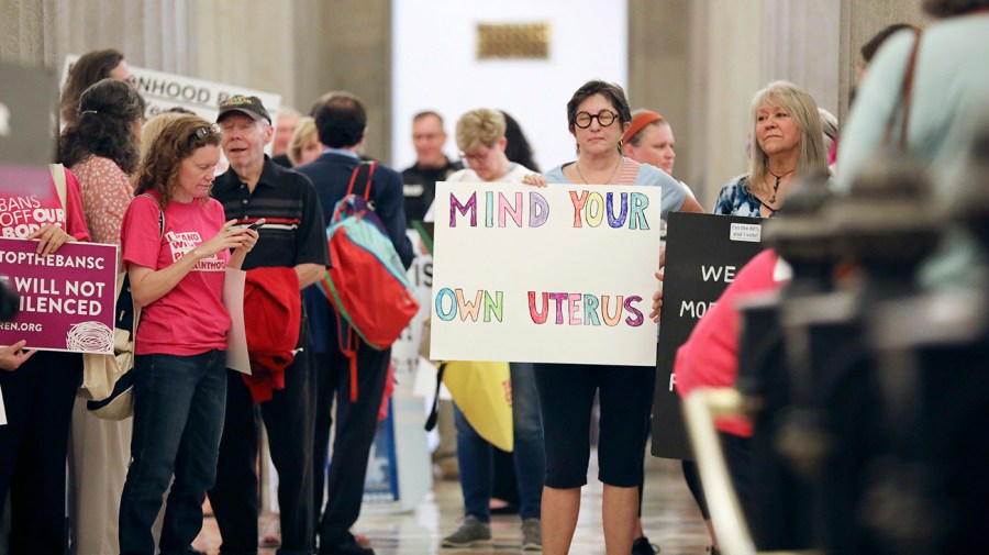 Protesters against a stricter ban on abortion in South Carolina stand in the Statehouse lobby on Tuesday, May, 23, 2023, in Columbia, S.C.