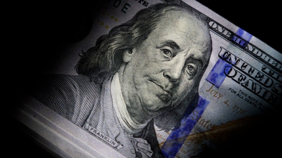 File - The likeness of Benjamin Franklin is seen on U.S. $100 bills, Thursday, July 14, 2022, in Marple Township, Pa. If the debt crisis now roiling Washington were eventually to send the United States crashing into recession, the repercussions of a first-ever default on the federal debt would reverberate around the world and quickly. (AP Photo/Matt Slocum, File)