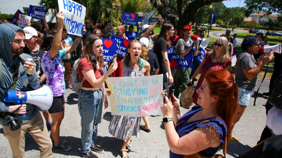 Protesters gather at the New College of Florida campus moments after Gov. Ron DeSantis (R) signed legislation there that blocks public colleges from using federal or state funding on diversity programs.