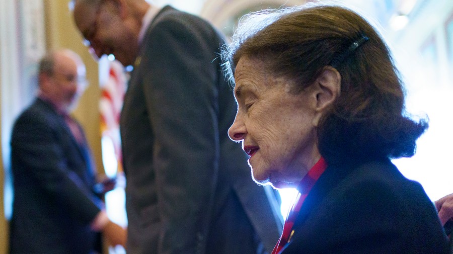 Sen. Dianne Feinstein (D-Calif.) returns to the Senate accompanied by Majority Leader Chuck Schumer (D-N.Y.)