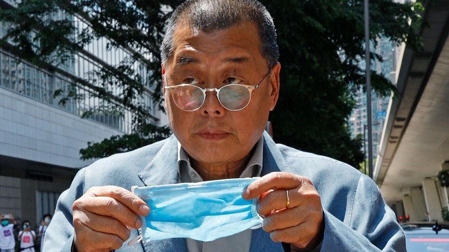 FILE - Hong Kong media tycoon Jimmy Lai, who founded local newspaper Apple Daily, is about to wear a face mask before entering a court in Hong Kong on May 5, 2020. A Hong Kong court on Friday, May 19, 2023 dismissed the jailed pro-democracy publisher's legal bid in his fight to use a British lawyer in his landmark national security trial. (AP Photo/Kin Cheung, File)