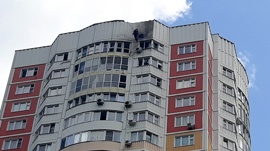 An investigator inspects a damage after a Ukrainian drone attacked an apartment building in Moscow, Russia, Tuesday, May 30, 2023. In Moscow, residents reported hearing explosions and Mayor Sergei Sobyanin later confirmed there had been a drone attack that he said caused "insignificant" damage.