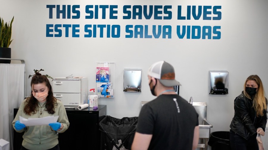 FILE - A sign on the wall reads "This site save lives" in Spanish and English at an overdose prevention center at OnPoint NYC in New York, Feb. 18, 2022. Across the U.S., drug overdoses killed an estimated 100,000 people in 2021, according to federal health officials. That has pushed lawmakers in Colorado, New Mexico and Nevada to consider joining New York in allowing what are often called “overdose prevention centers" — spaces where people can use illicit drugs under the supervision of trained staff who could reverse an overdose if necessary. (AP Photo/Seth Wenig, File)