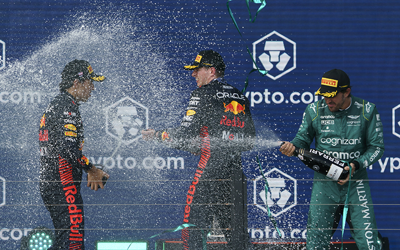 Mexican Formula One driver Sergio Pérez of Red Bull, Dutch Formula One driver Max Verstappen of Red Bull and Spanish Formula One driver Fernando Alonso of Aston Martin spray champagne