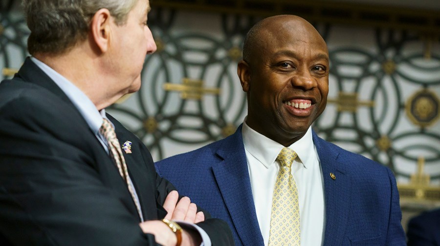 Sen. Tim Scott (R-S.C.) speaks with Sens. John Kennedy (R-La.) and Mike Rounds (R-S.D.)