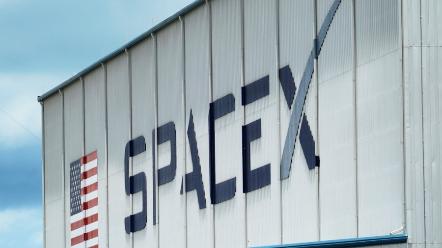 FILE - The SpaceX logo is displayed on a building, Tuesday, May 26, 2020, at the Kennedy Space Center in Cape Canaveral, Fla. (AP Photo/David J. Phillip, File)