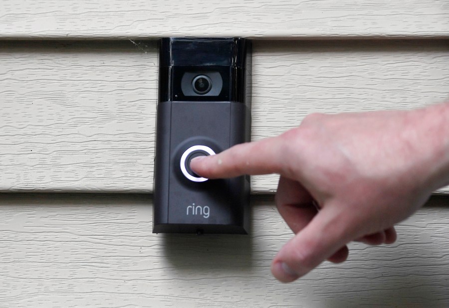 FILE - Ernie Field pushes the doorbell on his Ring doorbell camera, July 16, 2019, at his home in Wolcott, Conn. In a vote Wednesday, May 31, 2023, the Federal Trade Commission is ordering Amazon to pay more than $30 million in fines over privacy violations involving its voice assistant Alexa and its doorbell camera Ring. (AP Photo/Jessica Hill, File)