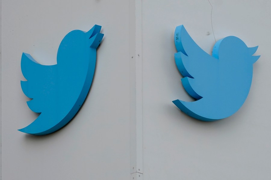 FILE - Twitter logos hang outside the company's offices in San Francisco, Monday, Dec. 19, 2022. Ella Irwin, a top Twitter executive responsible for safety and content moderation, has left the company. Her departure came after owner Elon Musk publicly complained about the platform’s handling of posts about transgender topics. (AP Photo/Jeff Chiu, File)