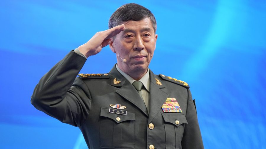 Chinese Defense Minister Li Shangfu salutes before delivering his speech on the last day of the 20th International Institute for Strategic Studies (IISS) Shangri-La Dialogue, Asia's annual defense and security forum, in Singapore, Sunday, June 4, 2023. (AP Photo/Vincent Thian)