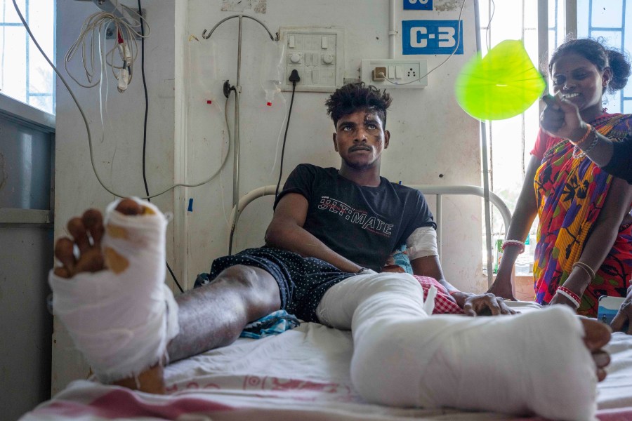 Gura Pallay, 24, who was onboard one of the two passenger trains that crashed Friday receives treatment at a hospital in Balasore district, in the eastern state of Orissa, India, Sunday, June 4, 2023. Pallay was watching another train pass by the one he was sitting in when he heard sudden, loud screeching. Before he could make sense of what was happening, he was thrown out of the train. Several survivors of the train crash in India that killed 275 people and injured more than 800 are still in shock and disbelief. (AP Photo/Rafiq Maqbool)