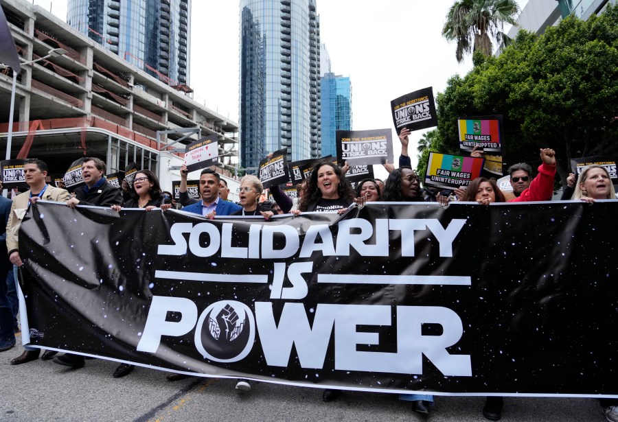 Union members march through downtown Los Angeles at the "Unions Strike Back" rally, Friday, May 26, 2023. Union members from the tourism and hospitality, Hollywood, public sector, education and logistics industries mobilized for a display of collective solidarity. (AP Photo/Chris Pizzello)