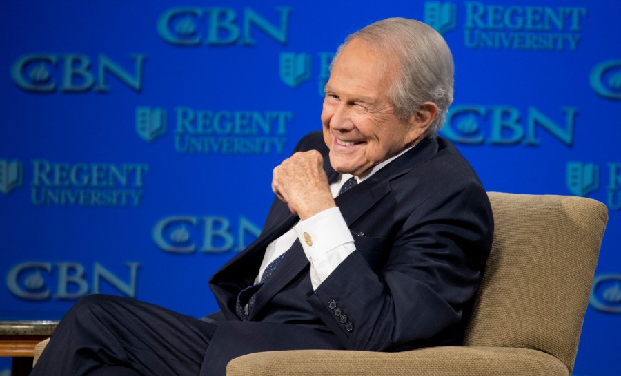 FILE - Rev. Pat Robertson listens as Republican presidential candidate Donald Trump speaks at Regent University in Virginia Beach, Va., Feb. 24, 2016.