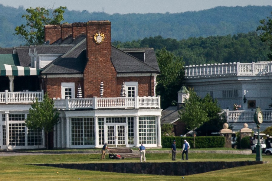 People play golf next to the Trump National Golf Club Bedminster's clubhouse in Bedminister on Friday, June 9 , 2023, in New Jersey. Former President Donald Trump has been indicted on charges of mishandling classified documents at his Florida estate. The remarkable development makes him the first former president in U.S. history to face criminal charges by the federal government that he once oversaw. (AP Photo/Eduardo Munoz Alvarez)