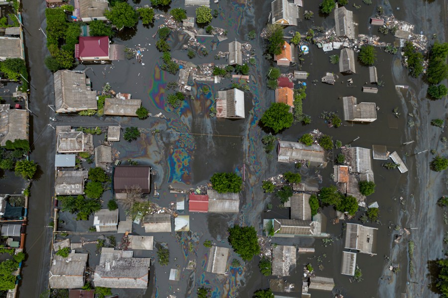 Houses are seen underwater and polluted by oil in a flooded neighbourhood in Kherson, Ukraine, Saturday, June 10, 2023. The destruction of the Kakhovka Dam in southern Ukraine is swiftly evolving into long-term environmental catastrophe. It affects drinking water, food supplies and ecosystems reaching into the Black Sea. (AP Photo)