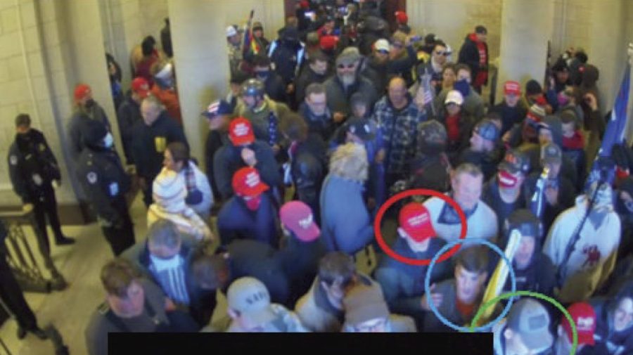 In this image from U.S. Capitol Police video, released and annotated by the Justice Department in the Statement of Facts supporting an arrest warrant, Joshua Abate, circled in green, Micah Coomer, circled in red, and Dodge Dale Hellonen, circled in blue, appear inside the U.S. Capitol on Jan. 6, 2021, in Washington. Abate and Hellonen, who were active-duty members of the Marines Corps when they stormed the U.S. Capitol, pleaded guilty on Monday, June 12, 2023, to riot-related criminal charges. Coomer, who was an active-duty Marine, pleaded guilty to the same misdemeanor charge in May. (Justice Department via AP)