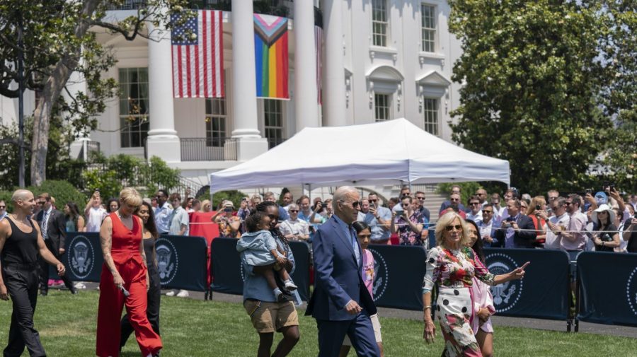 President Joe Biden, first lady Jill Biden and Betty Who, left in red, arrive for a Pride Month celebration on the South Lawn of the White House, Saturday, June 10, 2023, in Washington. (AP Photo/Manuel Balce Ceneta)