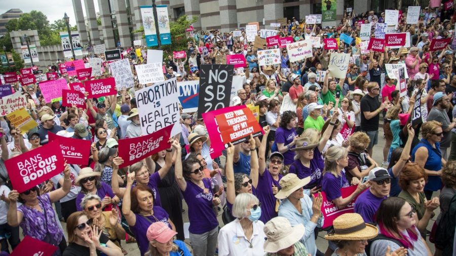 FILE - Hundreds of abortion ban veto supporters turned out to watch North Carolina Gov. Roy Cooper sign a veto of the on Bicentennial Mall in Raleigh Saturday, May 19, 2023. Abortion providers in North Carolina filed a federal lawsuit Friday, June 16, 2023, that challenges several provisions of a state law banning most abortions after 12 weeks of pregnancy in the dwindling days before the new restrictions take effect.(Travis Long/The News & Observer via AP, File)