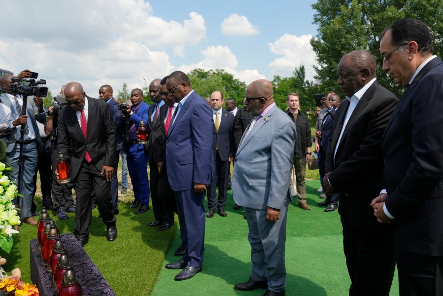 First row from right, Egypt's Prime Minister Mustafa Madbuly, South African President Cyril Ramaphosa, President of the Union of Comoros Azali Assoumani, Senegal's President Macky Sall, and Zambia's President Hakainde Hichilema attend a commemoration ceremony at a site of a mass grave in Bucha, on the outskirts of Kyiv, Ukraine, Friday, June 16, 2023. South African President Cyril Ramaphosa arrived in Ukraine on Friday as part of a delegation of African leaders and senior officials seeking ways to end Kyiv's 15-month war with Russia. (AP Photo/Efrem Lukatsky)