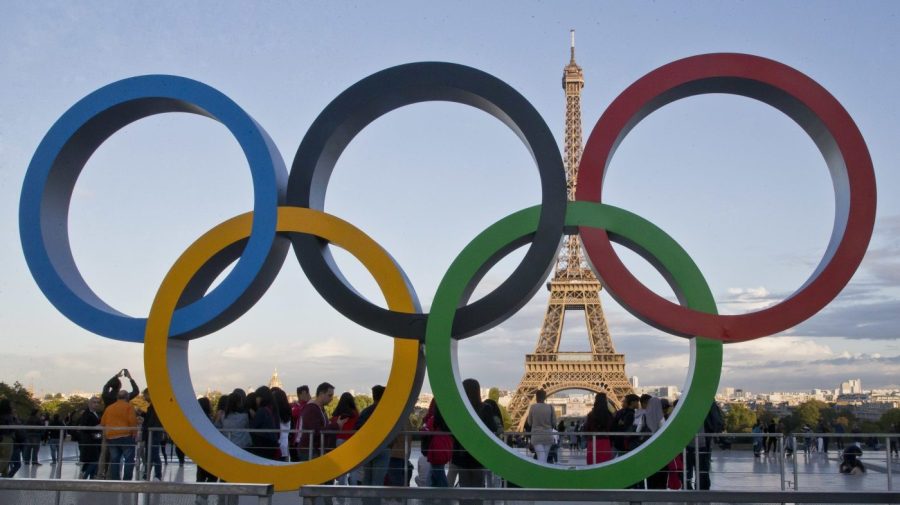 FILE - The Olympic rings are set up in Paris, France, Thursday, Sept. 14, 2017 at Trocadero plaza that overlooks the Eiffel Tower, a day after the official announcement that the 2024 Summer Olympic Games will be in the French capital. French investigators searched the headquarters of Paris Olympic organizers on Tuesday in a probe into suspected corruption, according to the national financial prosecutor's office. (AP Photo/Michel Euler, File)