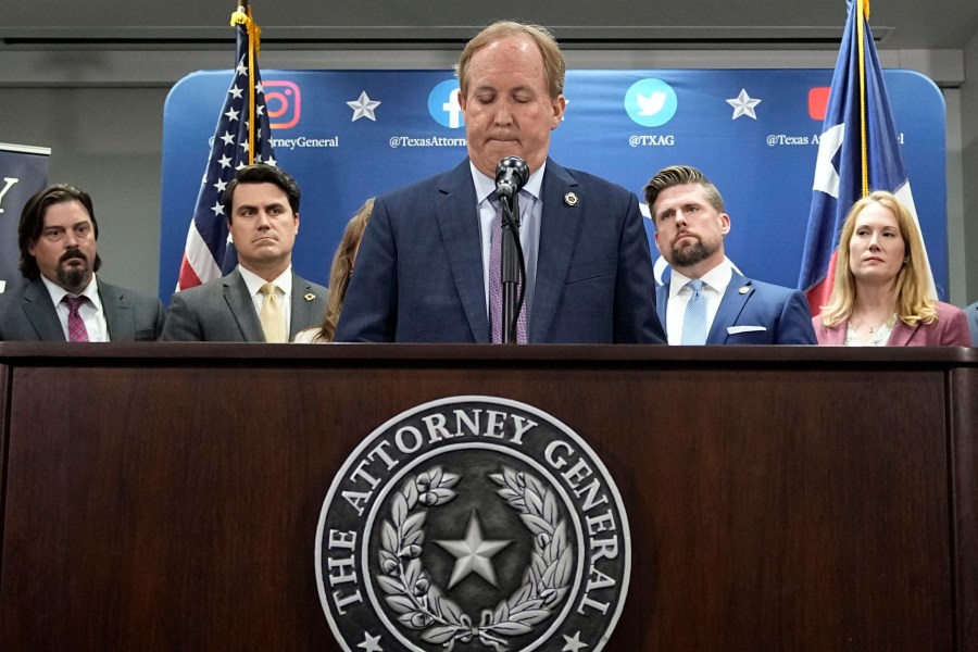 Texas state Attorney General Ken Paxton, center, flanked by his staff, makes a statement at his office in Austin, Texas, Friday, May 26, 2023. An investigating committee says the Texas House of Representatives will vote Saturday on whether to impeach state Attorney General Ken Paxton. (AP Photo/Eric Gay)