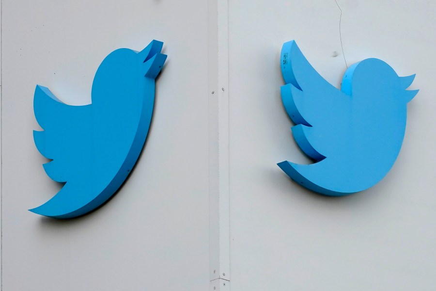 FILE - Twitter logos hang outside the company's offices in San Francisco, on Dec. 19, 2022. Australia's online safety watchdog has on Thursday, June 22, 2023, issued a legal notice to Twitter demanding an explanation of what the social media giant is doing to tackle a surge in online hate since Tesla CEO Elon Musk bought the platform. (AP Photo/Jeff Chiu, File)