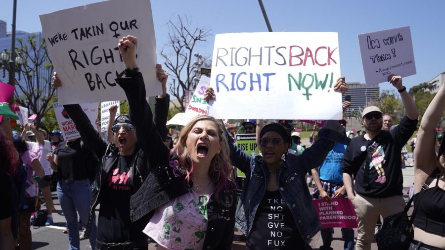 FILE - Supporters cheer up as Vice President Kamala Harris gives remarks at the Women's March in Los Angeles Saturday, April 15, 2023. One year ago, the U.S. Supreme Court rescinded a five-decade-old right to abortion, prompting a seismic shift in debates about politics, values, freedom and fairness. (AP Photo/Damian Dovarganes, File)