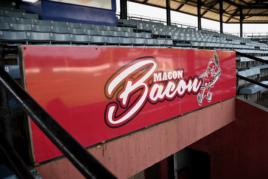 The logo for the Macon Bacon baseball team is displayed on a sign at Luther Williams Field in Macon, Ga., on May 24, 2022. A doctors' group that promotes plant-based eating and animal rights is makin' a fuss over the Macon Bacon baseball team. The Physicians Committee for Responsible Medicine has sent a letter urging the Georgia summer collegiate team to change its name, WMAZ-TV reported Wednesday, June 21, 2023. The group has also sponsored a billboard imploring Macon fans to “keep bacon off your plate.” (Jason Vorhees/The Macon Telegraph via AP)