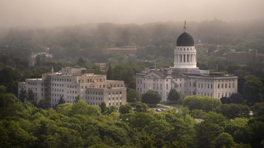 The morning fog lifts beyond the Burton M. Cross Building, left, and the State House, Wednesday, June 21, 2023, in Augusta, Maine. The legislature is working to wrap up the current session. (AP Photo/Robert F. Bukaty)