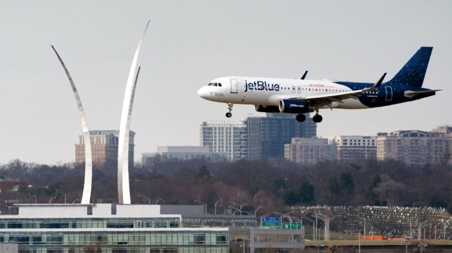 FILE - A JetBlue passenger flight lands at Reagan Washington National Airport in Arlington, Va., across the Potomac River from Washington, Wed., Jan. 19, 2022. Transportation Secretary Pete Buttigieg is warning airlines to be ready when wireless companies power up their 5G service next month. Buttigieg told an airline trade group Friday, June 23, 2023, that planes won't be allowed to land in poor visibility if they lack equipment to avoid radio interference from 5G. On July 1, AT&T, Verizon and other wireless carriers will be free to boost the power of their 5G signals. (AP Photo/J. Scott Applewhite, File)