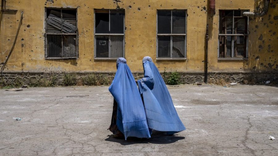 FILE - Afghan women wait to receive food rations distributed by a humanitarian aid group, in Kabul, Afghanistan, on May 28, 2023. The supreme leader of the Taliban released a message Sunday, June 25, claiming that his government has taken the necessary steps for the betterment of women's lives in Afghanistan, where women are banned from public life and work and girls' education is severely curtailed.(AP Photo/Ebrahim Noroozi, File)