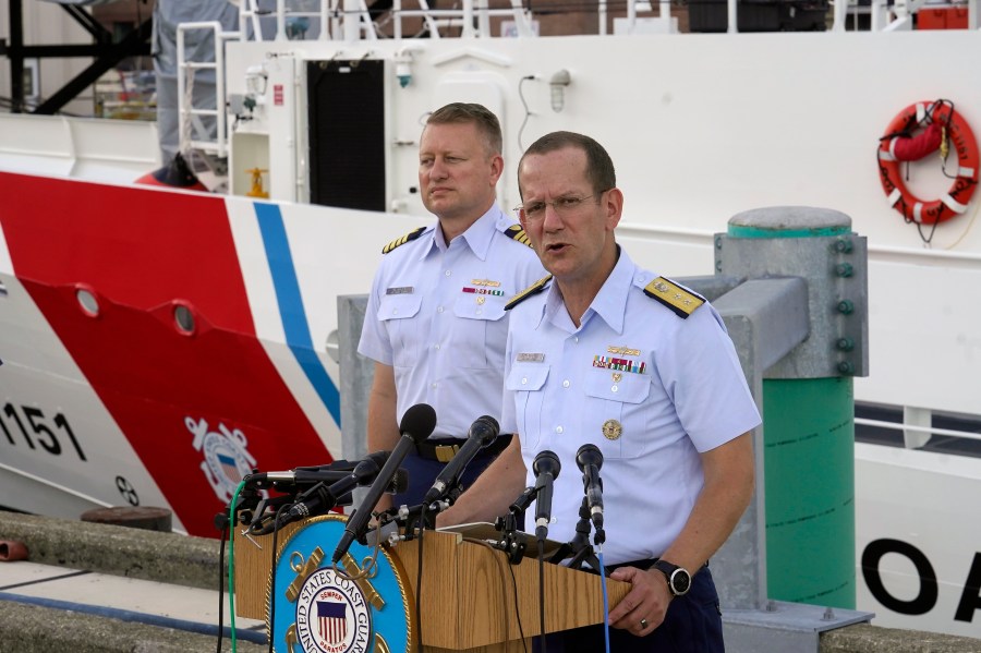 U.S. Coast Guard Rear Adm. John Mauger, commander of the First Coast Guard District, right, speaks to members of the media as Capt. Jason Neubauer, chief investigator, U.S. Coast, left, looks on during a news conference, Sunday, June 25, 2023, at Coast Guard Base Boston, in Boston. The U.S. Coast Guard said it is leading an investigation into the loss of the Titan submersible that was carrying five people to the Titanic, to determine what caused it to implode. (AP Photo/Steven Senne)