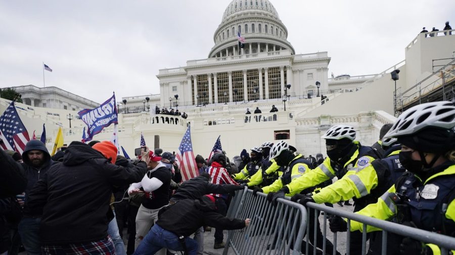 Rioters supporting President Donald Trump try to break through a police barrier at the Capitol in Washington, on Jan. 6, 2021.