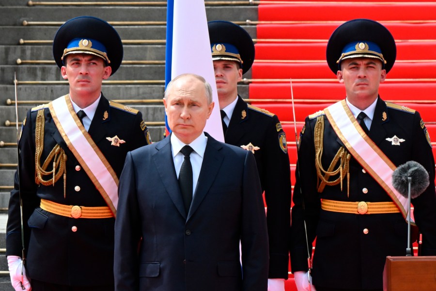 Russian President Vladimir Putin listens to the national anthem prior to delivering a speech to the units of the Russian Defense Ministry, the Russian National Guard (Rosgvardiya), the Russian Interior Ministry, the Russian Federal Security Service and the Russian Federal Guard Service, who ensured order and legality during the mutiny, at the Kremlin in Moscow, Russia, Tuesday, June 27, 2023. (Sergei Guneyev, Sputnik, Kremlin Pool Photo via AP)