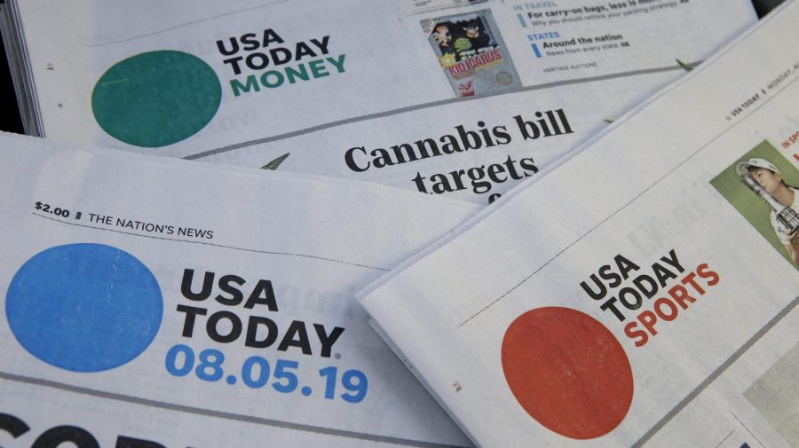 Sections of a USA Today newspaper are displayed.