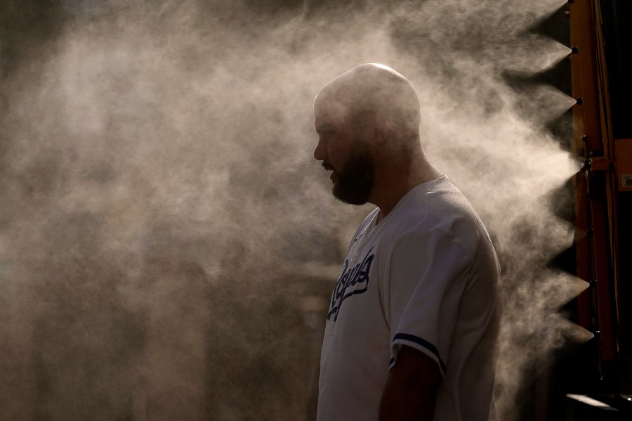 A man cools off in a mister at Kauffman Stadium as temperatures approach 100 degrees fahrenheit before a baseball game between the Kansas City Royals and the Cleveland Guardians, Wednesday, June 28, 2023, in Kansas City, Mo. (AP Photo/Charlie Riedel)