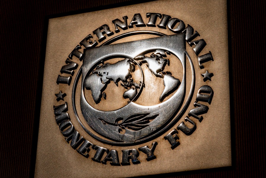 The logo of the International Monetary Fund is visible on its building.