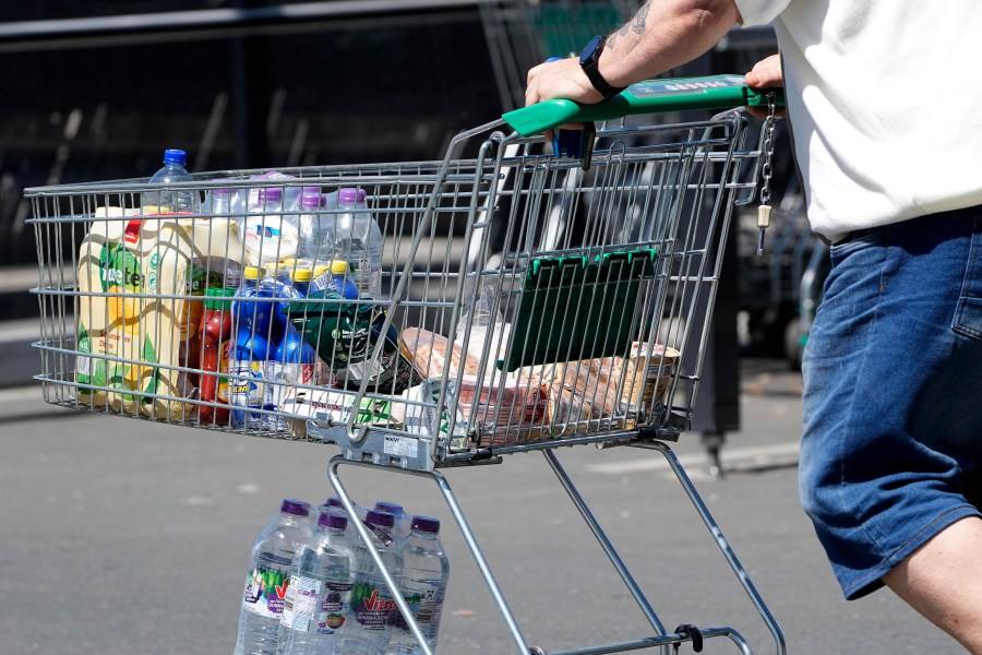 FILE - A man pushes a shopping cart outside a supermarket in Gelsenkirchen, Germany, on May 31, 2023. Inflation in Europe slid again in June but fell too slowly to offer much relief to shoppers grumbling over price tags or to stop more interest rate hikes that will raise the cost of borrowing across the economy. (AP Photo/Martin Meissner, File)