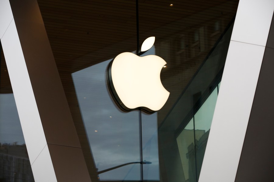 FILE - An Apple logo adorns the facade of the downtown Brooklyn Apple store on March 14, 2020, in New York. Apple is near to becoming the first publicly traded company to close a trading day with a $3 trillion market value, marking another milestone for a technology juggernaut that has reshaped society with a line-up of products that churn out eye-popping profits. (AP Photo/Kathy Willens, File)