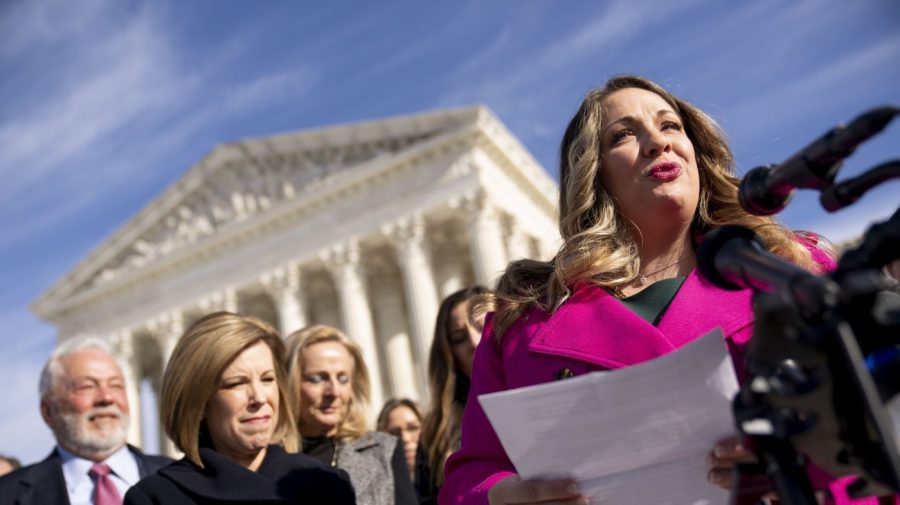 FILE - Lorie Smith, a Christian graphic artist and website designer in Colorado, right, accompanied by her lawyer, Kristen Waggoner of the Alliance Defending Freedom, second from left, speaks outside the Supreme Court in Washington, Monday, Dec. 5, 2022, after her case was heard before the Supreme Court. In a defeat for gay rights, the Supreme Court's conservative majority ruled Friday, June 30, 2023, Smith who wants to design wedding websites can refuse to work with same-sex couples. (AP Photo/Andrew Harnik, File)