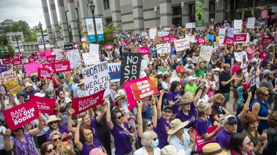 FILE - Hundreds of abortion ban veto supporters turned out to watch North Carolina Gov. Roy Cooper sign a veto of the on Bicentennial Mall in Raleigh Saturday, May 19, 2023. Abortion providers in North Carolina filed a federal lawsuit Friday, June 16, 2023, that challenges several provisions of a state law banning most abortions after 12 weeks of pregnancy in the dwindling days before the new restrictions take effect.(Travis Long/The News & Observer via AP, File)