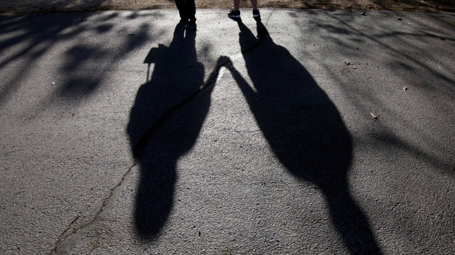 This Sept. 20, 2012 file photo shows the shadows of a young woman from Rockford, Ill., left, with her husband. When her doctor said a medical condition made her unplanned pregnancy too risky, she decided to go ahead with an abortion in 2011. Abortion protesters were picketing outside when the young couple arrived in the parking lot for the procedure. One protester was particularly persistent. "She was just blatantly yelling at my fiance and I. I turned around and said, 'Listen, lady, you don't know what everyone is going through.' She was just saying that I was already a mom and I have all these options - the opposite of what my doctor was telling me. "I looked at her and told her, 'I'm doing this to save my life.'" (AP Photo/Nam Y. Huh, File)