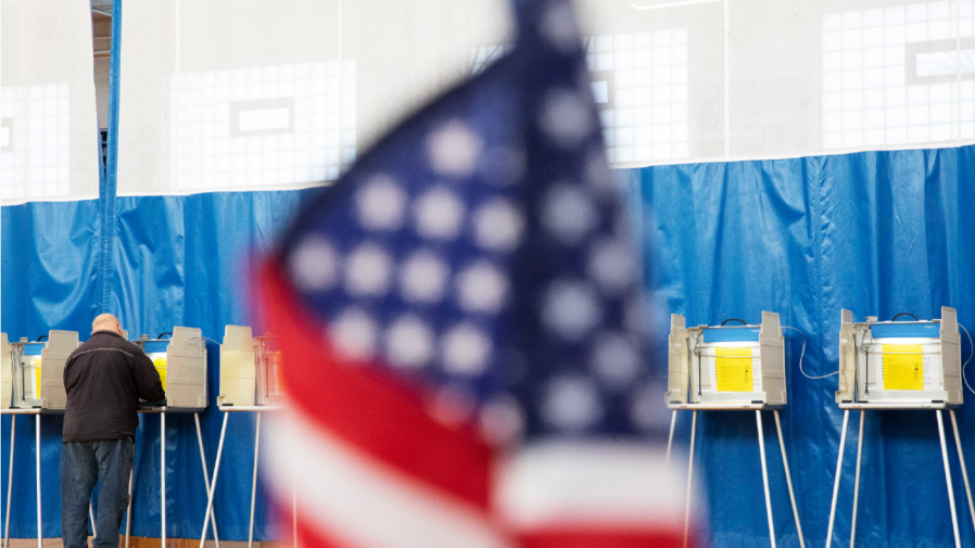 A voter casts a ballot in the Massachusetts presidential primaries, Tuesday, March 3, 2020, in Seekonk, Mass. Voters registered as Democrats or Republicans must pull their party's ballots. Voters not enrolled in any party, the majority of Massachusetts voters, can pull any party ballot. (AP Photo/David Goldman)