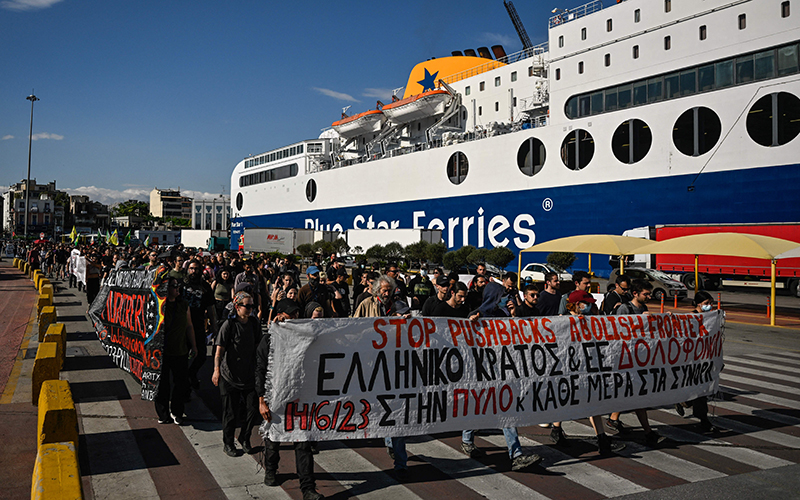 Protesters carry a banner that reads "Stop pushbacks, abolish Frontex, the Greek state and EU murder” during a Sunday march